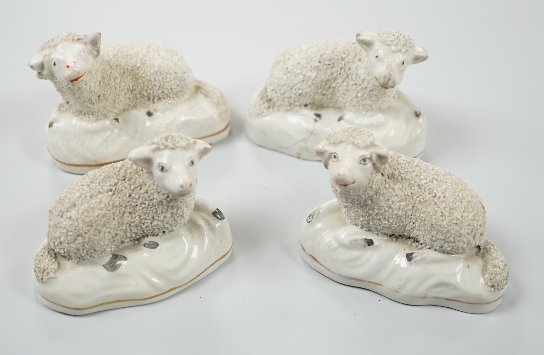 Four small Staffordshire models of recumbent sheep, c.1830-50. 8.5cm long, Provenance: Dennis G.Rice collection